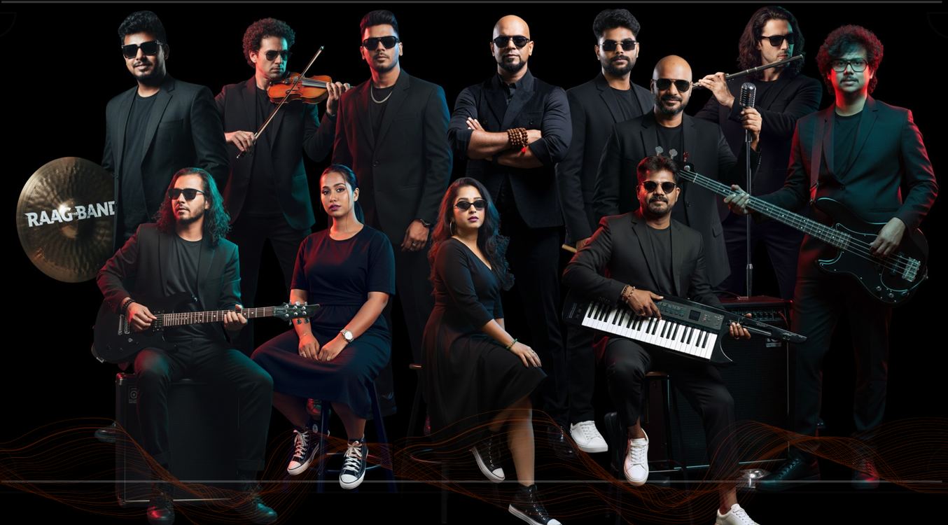 Raag The Band members in black with guitars, violin and keyboard