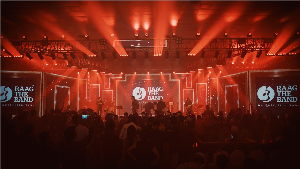 Raag The Band on a stage washed in red light